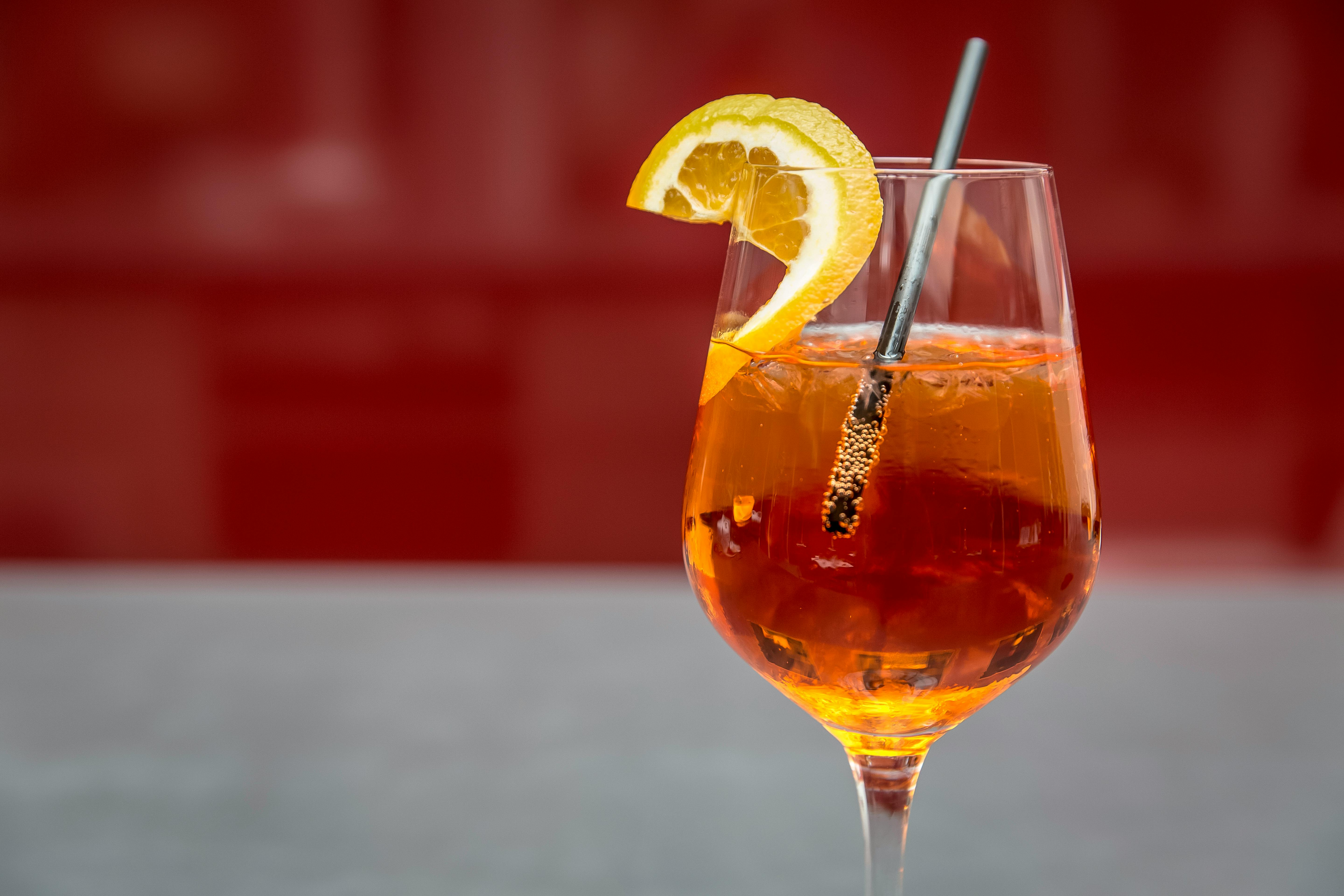 pexels-photo-128242-128242 Bright Aperol spritz with lemon slice on a glass, perfect for summer refreshment.