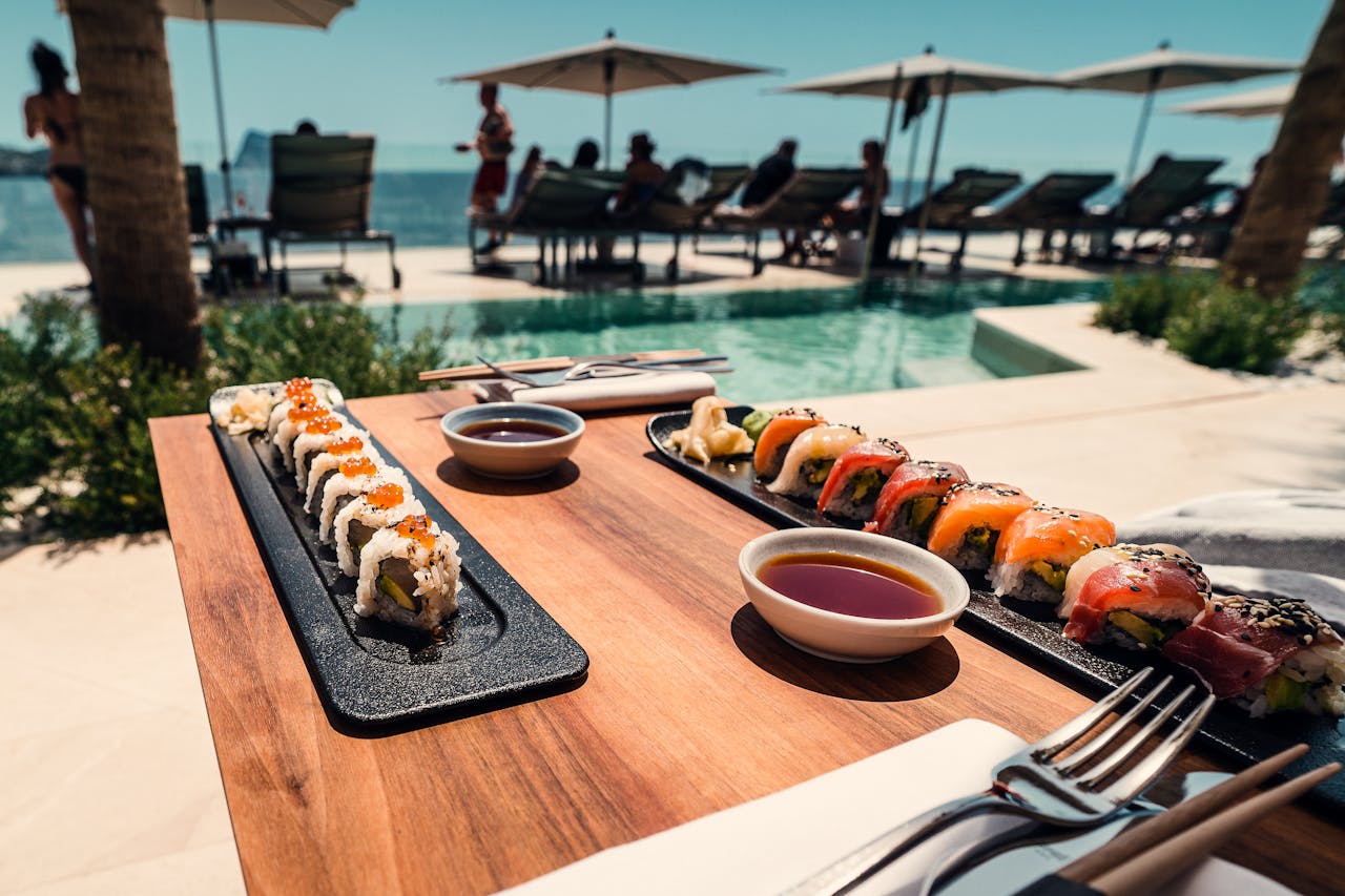 pexels-photo-3475617 Delicious sushi rolls served by a poolside in sunny Ibiza, perfect for a summer vacation dining.